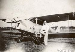 Jack Lister poses with the CO's deHavilland Moth.