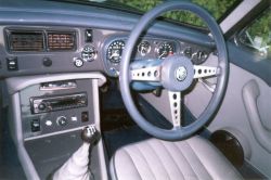 Dashboard painted grey surrounded by blue leather