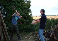 John and Robert chopping wood dangerously