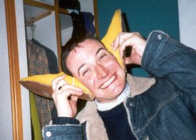 Mark using John's yellow pixi boots  as ears